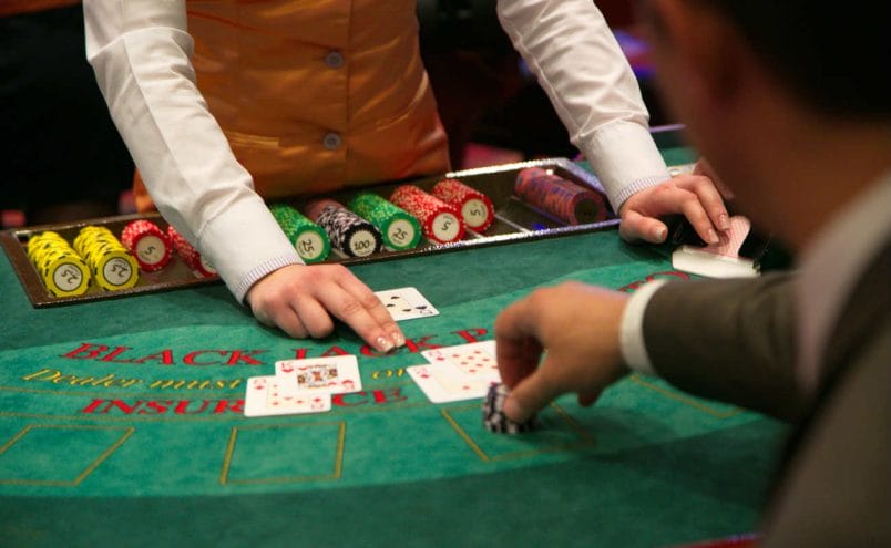 Dealer puts down a card on blackjack table